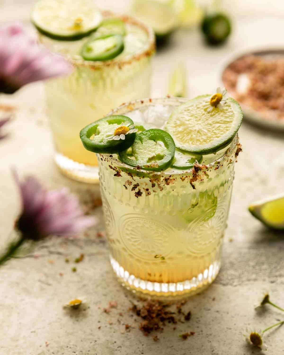 Side view of skinny spicy margarita with garnish.
