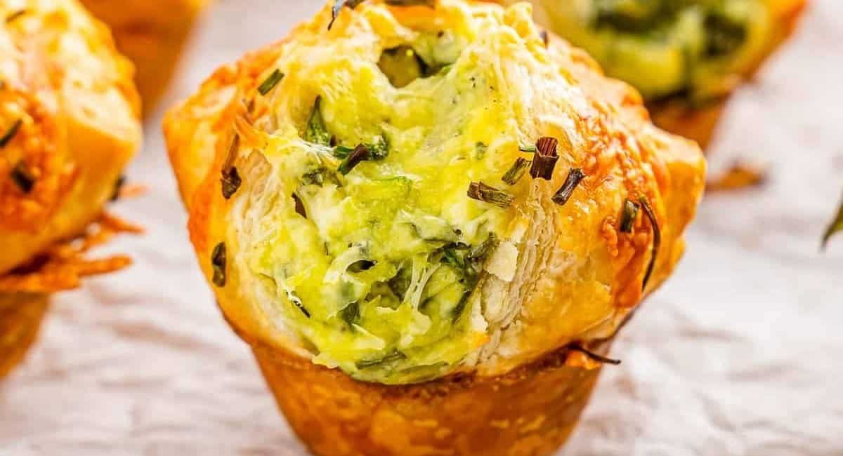 Up close side profile image of spinach puffs with puff pastry and cheese.