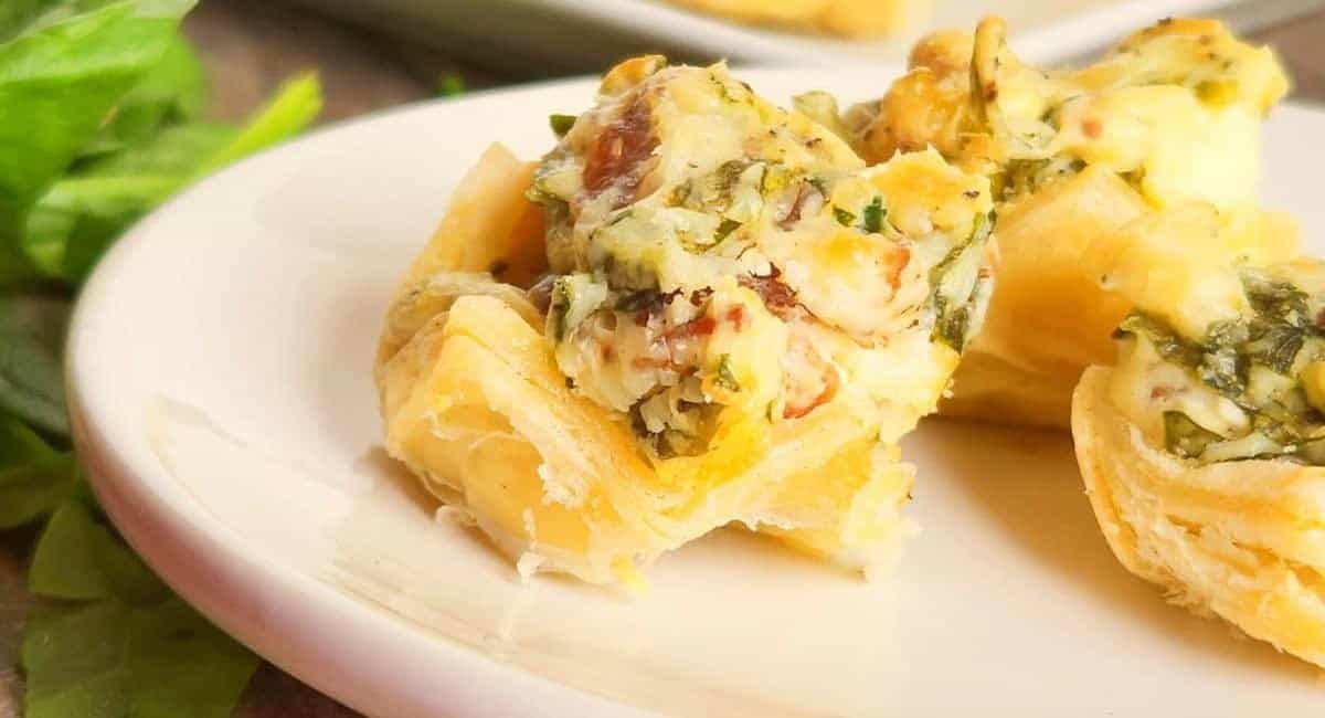 Up close image of mini cheese and spinach tartlets.
