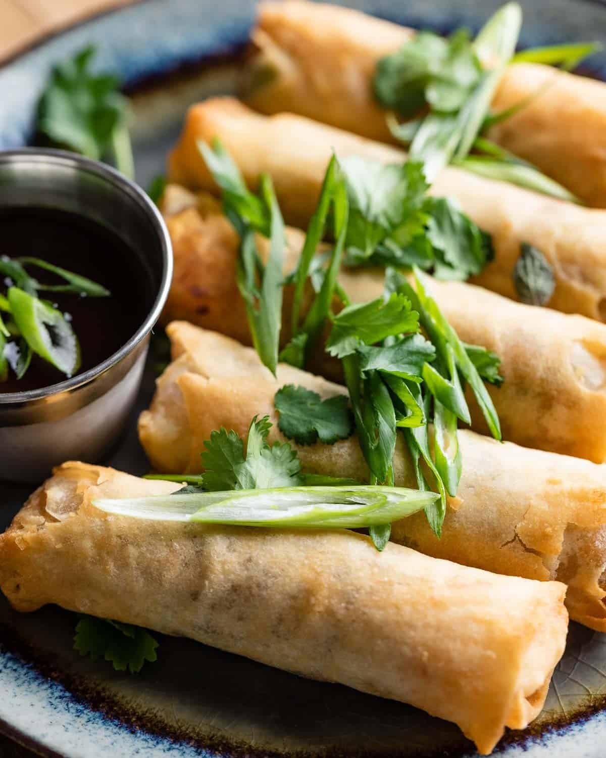 Up close image of air fryer frozen spring rolls.