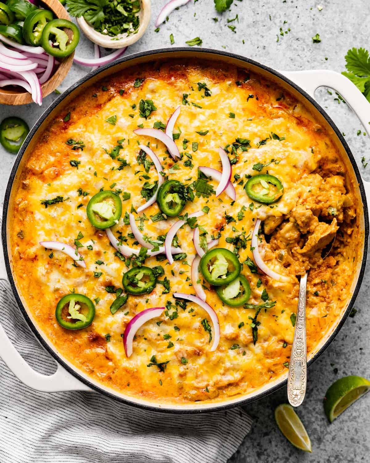 Overhead image of Mexican chicken and rice casserole with garnish.