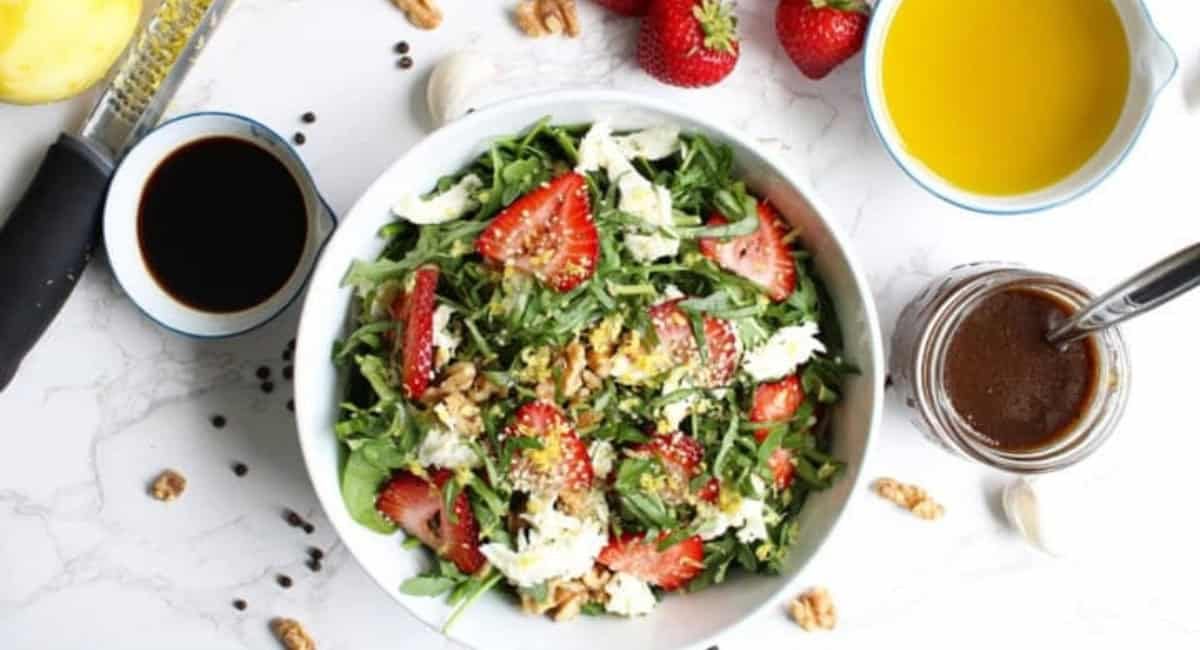 Overhead image of strawberry salad with lemon and basil.