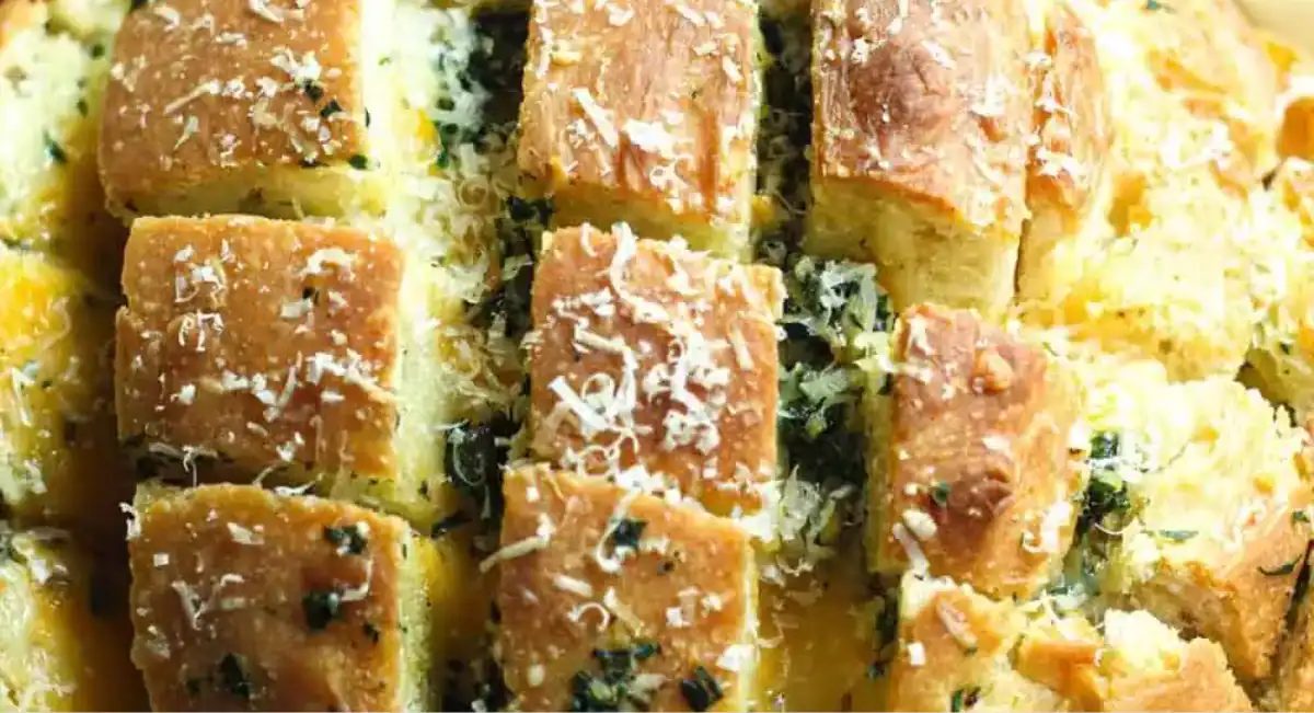 Overhead up close image of stuffed garlic bread with garnish.
