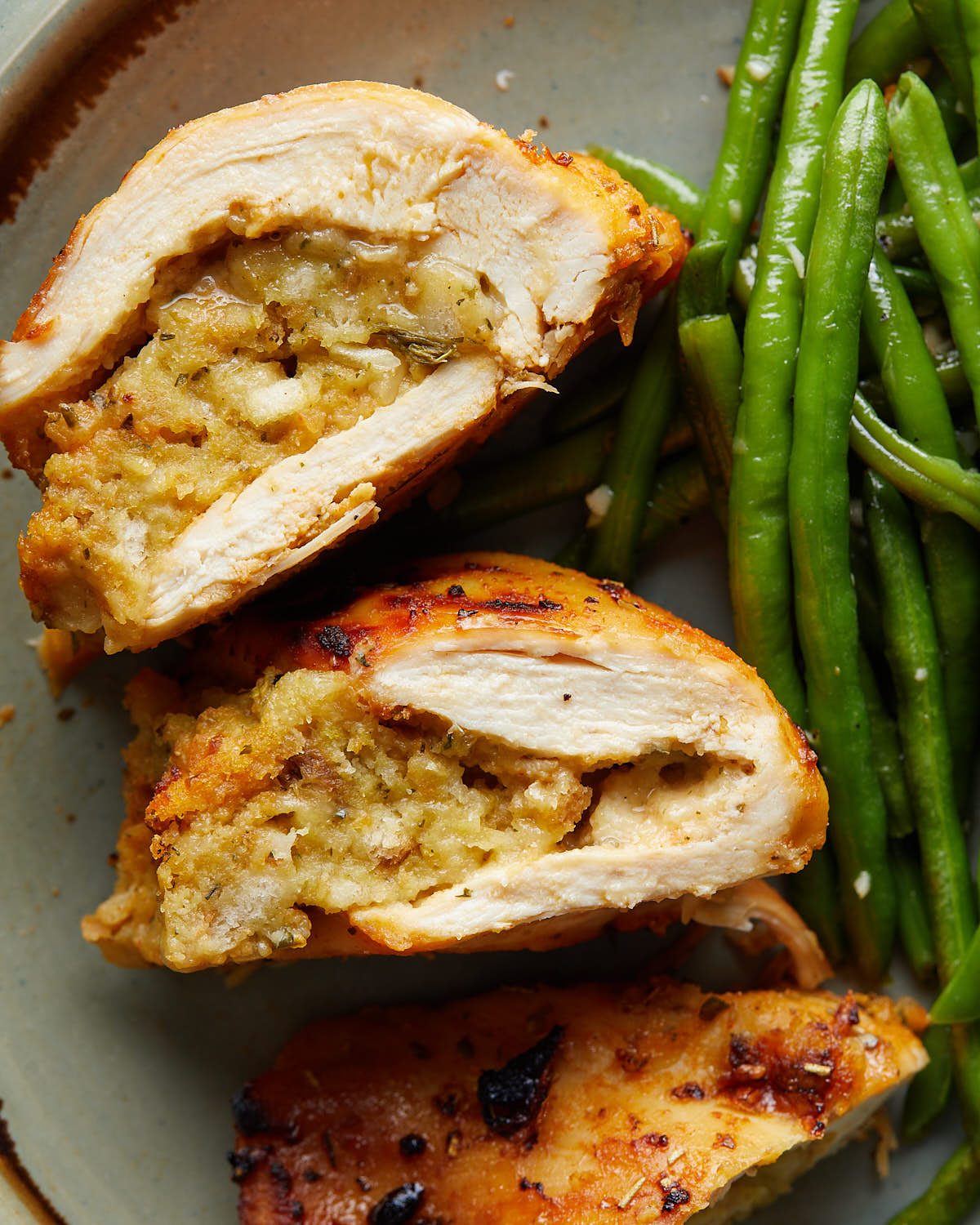 Up close overhead image of stuffing stuffed chicken breasts.