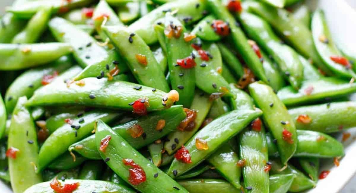 Up close image of Asian sugar snap peas with garnish.