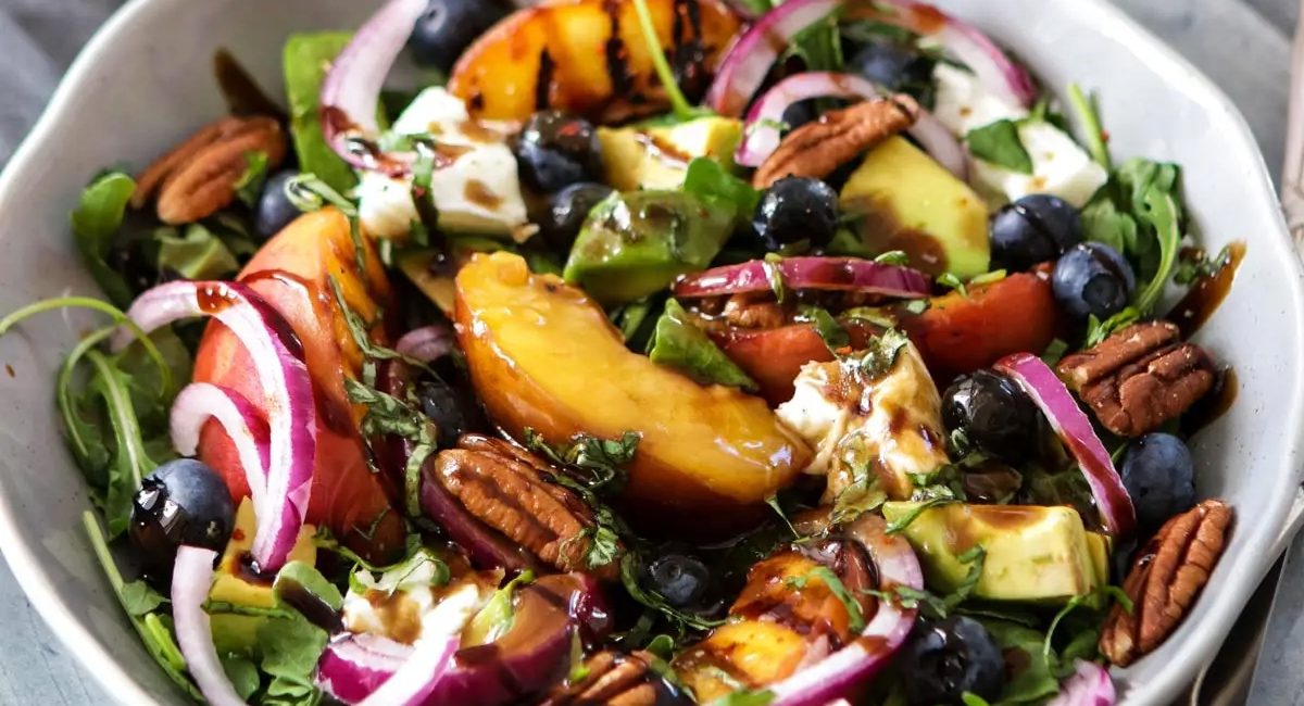 Overhead image of summer grilled peach salad with burrata.