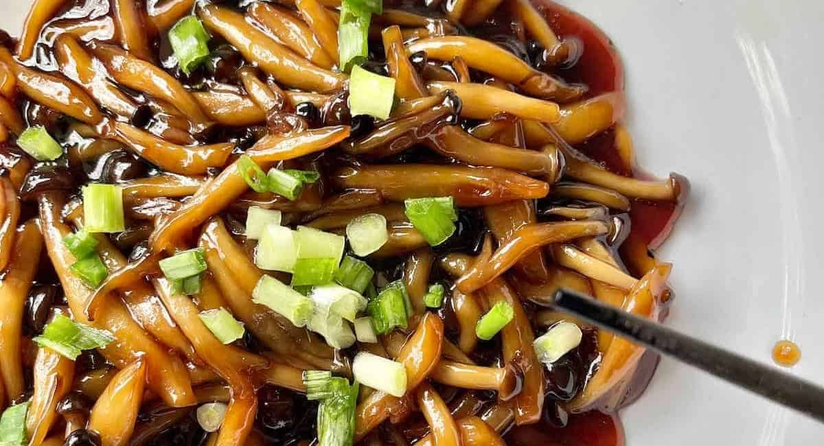 Overhead image of teriyaki mushrooms with garnish.