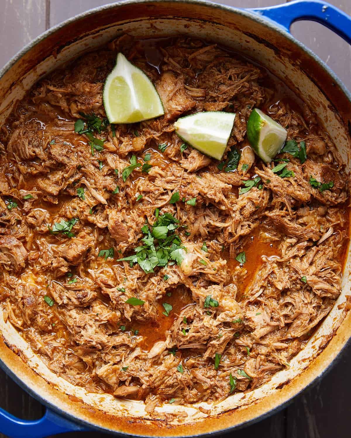 Overhead image of pulled pork for street tacos with garnish.