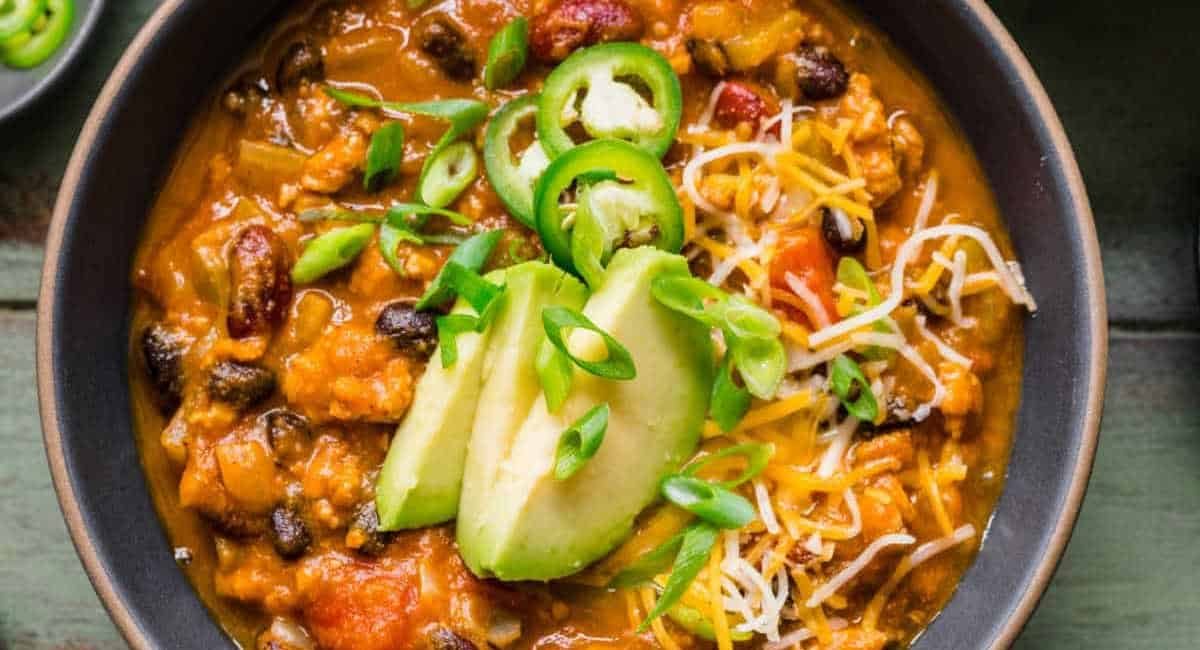 Overhead image of turkey pumpkin chili with garnish.
