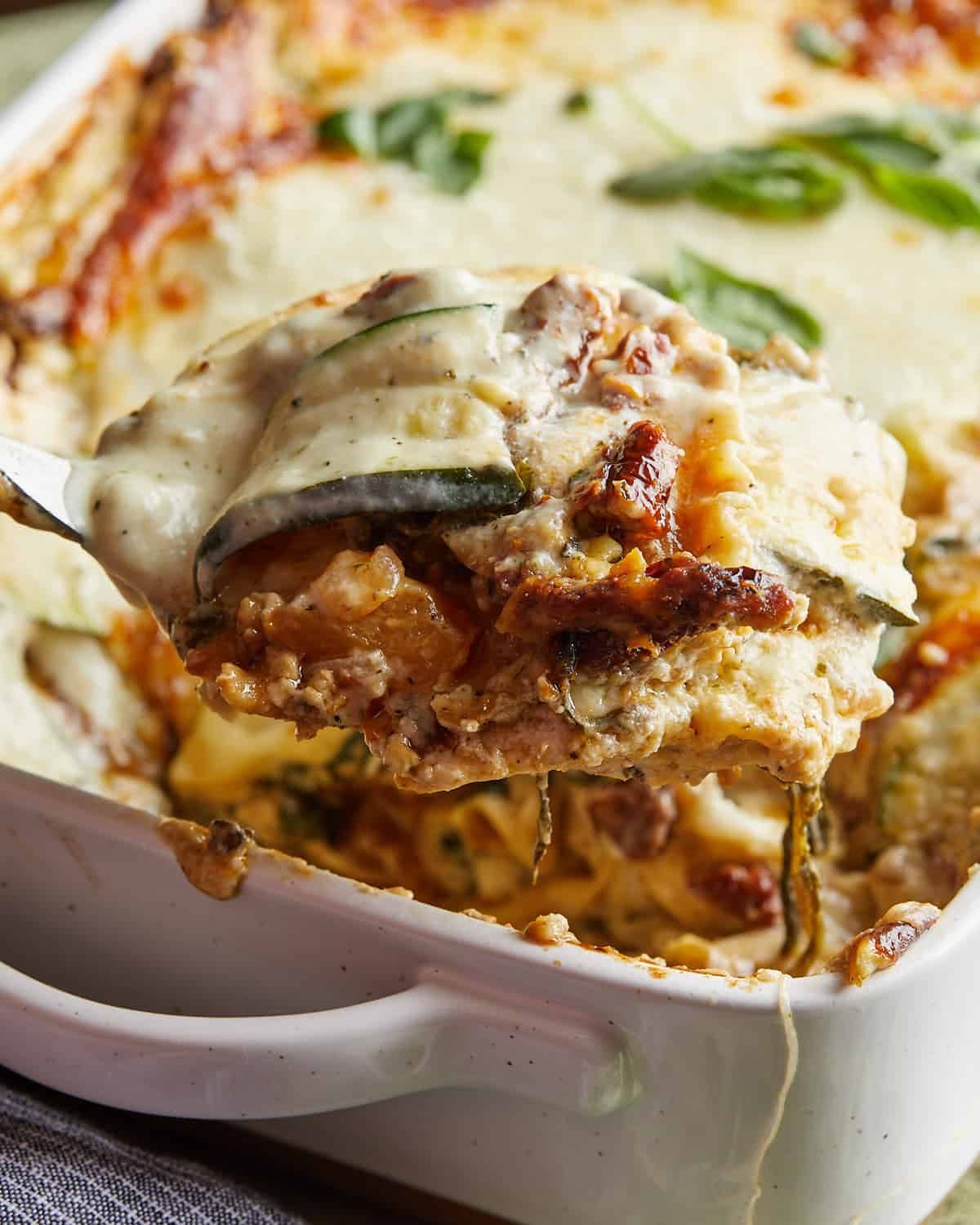Side image of veggie lasagna with white sauce.