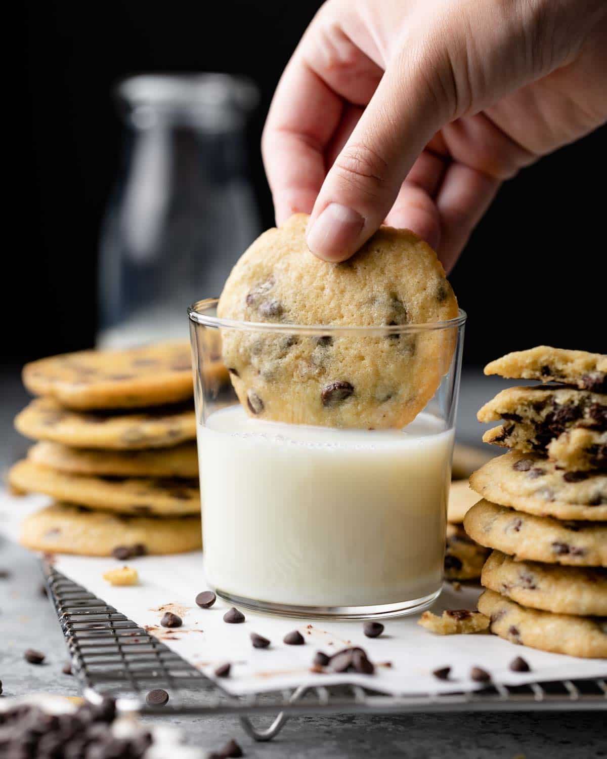 side view of cookie being dunked in milk