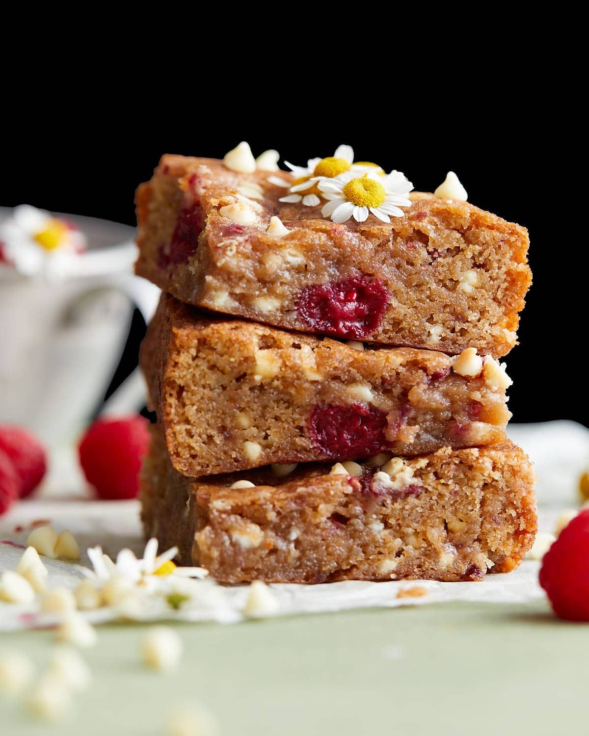 Image of white chocolate and raspberry blondies with garnish.