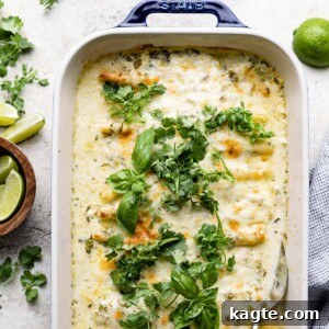 Green Chili Beef Enchiladas with White Sauce in a baking dish.
