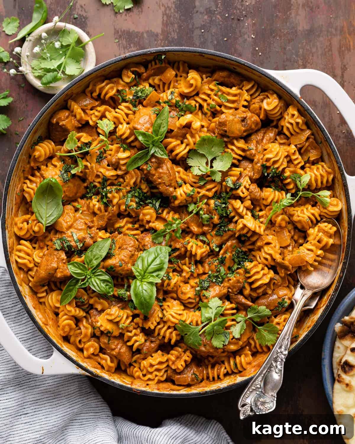 Overhead image of butter chicken pasta in white pan.