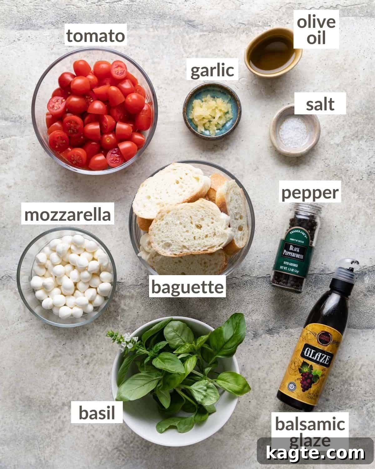 Creamy Mozzarella Bruschetta 3 A collection of fresh ingredients laid out, including vibrant grape tomatoes, small mozzarella pearls, fresh basil leaves, and a head of garlic, for making bruschetta.