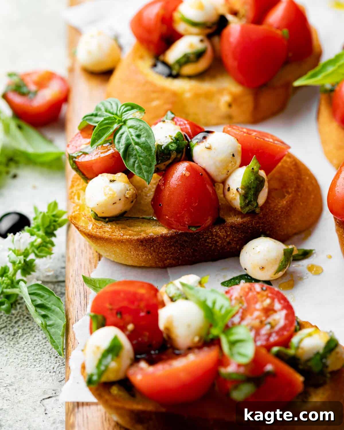 Creamy Mozzarella Bruschetta 7 Close-up of Bruschetta with Mozzarella, drizzled with balsamic glaze and garnished with fresh basil, on a light plate.