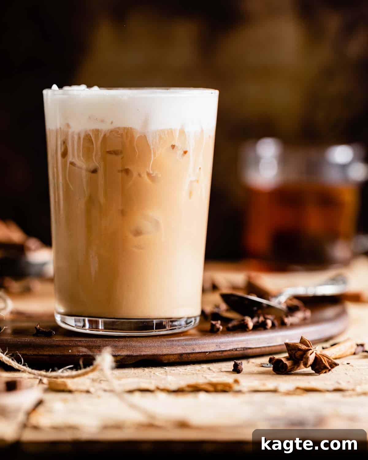 Craft Your Own Starbucks Chai Tea Latte 2 side view of iced chai tea latte, showing layers of milk and chai concentrate with ice