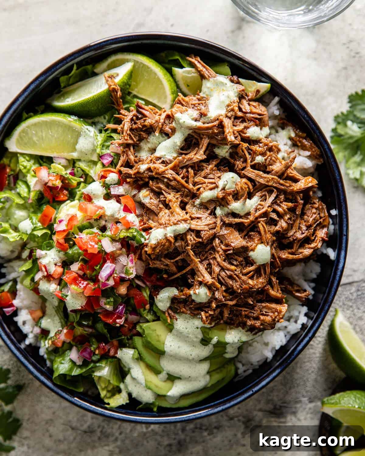 overhead of instant pot shredded beef over rice with pico and lettuce