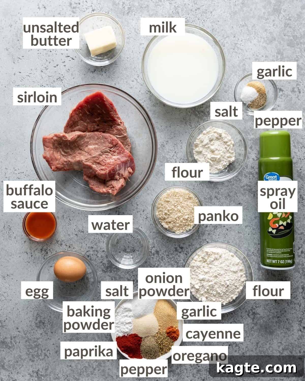 Crispy Air Fryer Chicken Fried Steak 3 A collection of ingredients laid out on a wooden board, ready to make chicken fried steak in the air fryer.