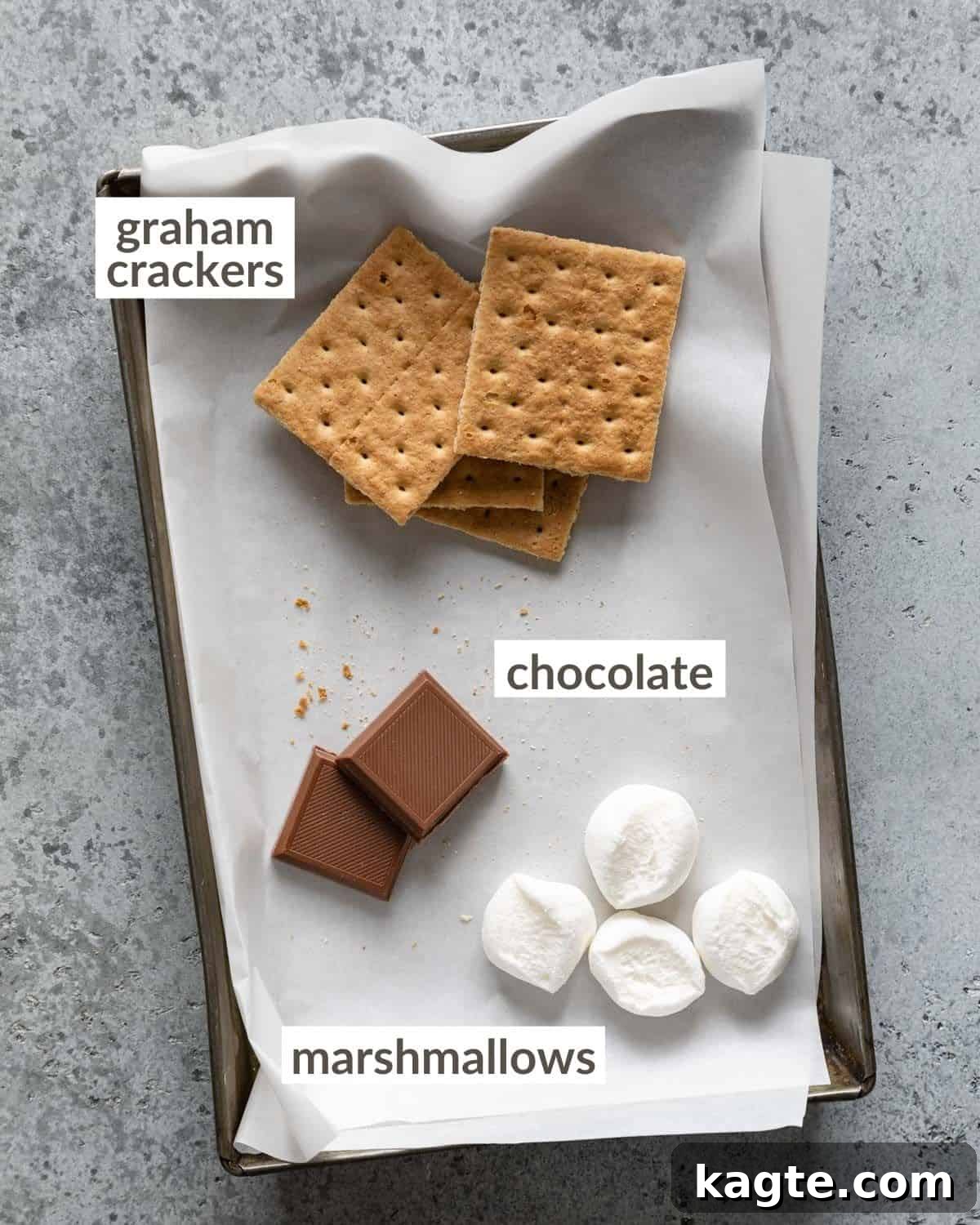 Gooey Air Fryer S'mores 3 Overhead shot of the three main ingredients: graham crackers, jumbo marshmallows, and chocolate squares, neatly arranged on a tray.