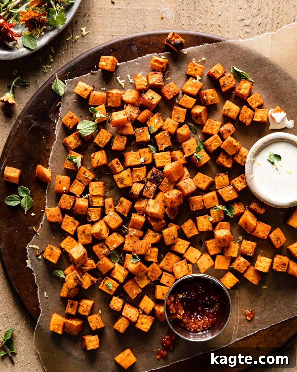 Crispy Air Fryer Sweet Potato Cubes 2 Crispy Air Fryer Sweet Potato Cubes served on a platter with garlic aioli dipping sauce