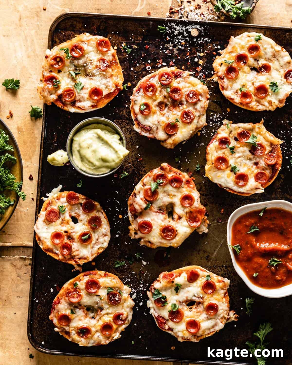 Crispy Air Fryer Bagel Bites Frozen and Fresh 2 Overhead shot of freshly made air fryer bagel bites, topped with melted cheese and mini pepperonis, resting on a baking sheet, ready to be served as a quick meal or party snack.