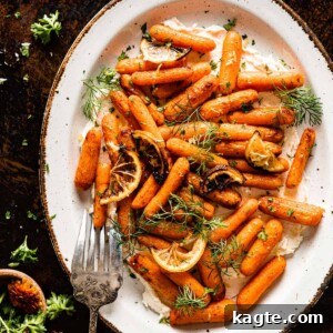 Platter of Air Fryer Baby Carrots over whipped feta, garnished with fresh dill, ready for serving.