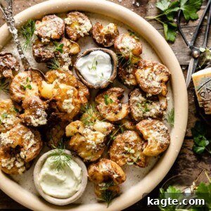 Close-up of golden brown air fryer smashed potatoes on a serving plate.