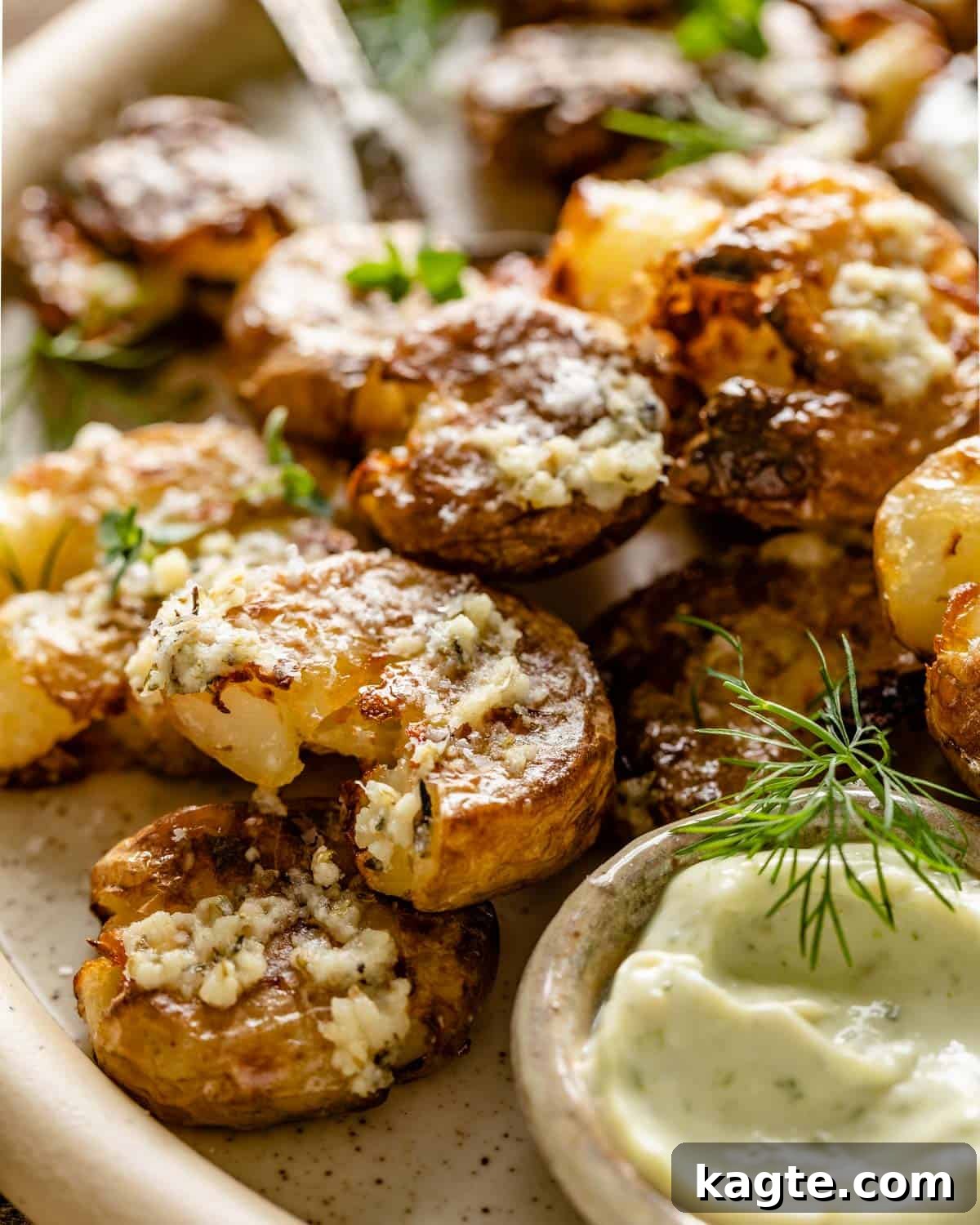 Golden Smashed Air Fryer Potatoes 7 Close up shot of a single perfectly crispy air fryer smashed potato, showcasing its golden texture and flecks of herbs and parmesan.