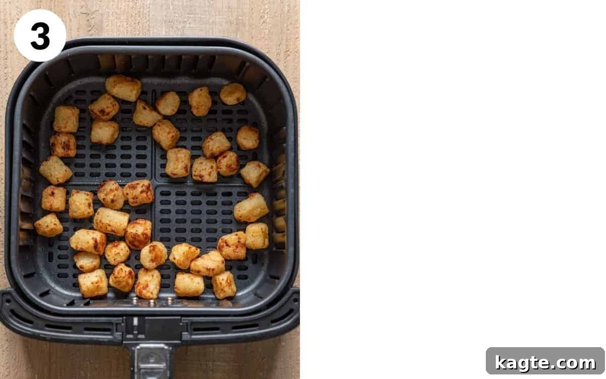 Close-up of perfectly air-fried cauliflower gnocchi, golden brown and crispy, resting in an air fryer basket after cooking.