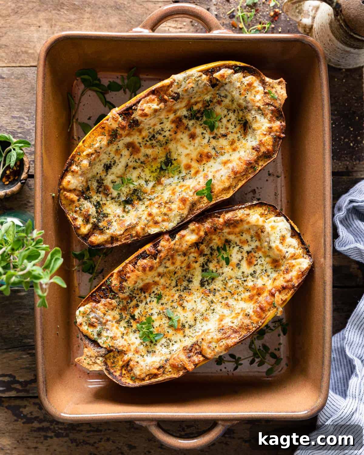 Effortless Air Fryer Spaghetti Squash 2 Air fried spaghetti squash in a brown casserole dish.