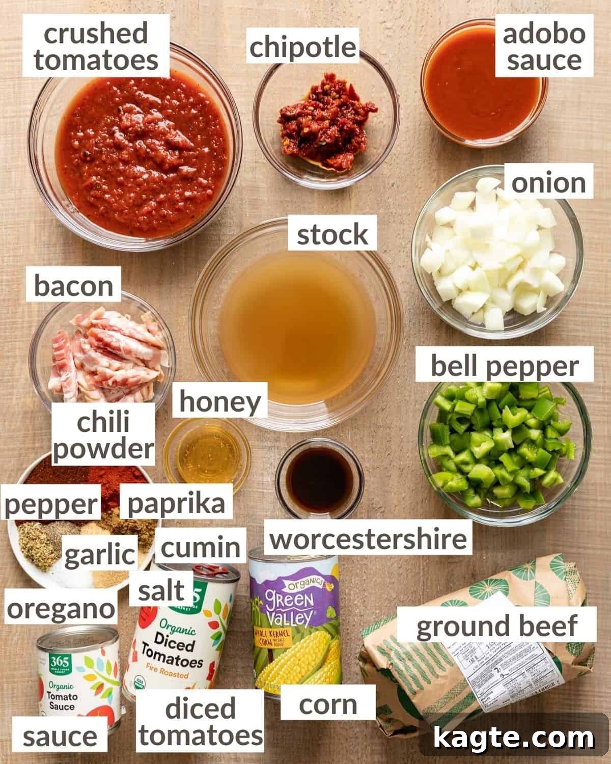 overhead of fresh ingredients for instant pot chili without beans, including ground beef, diced bacon, onions, bell peppers, tomatoes, and various spices