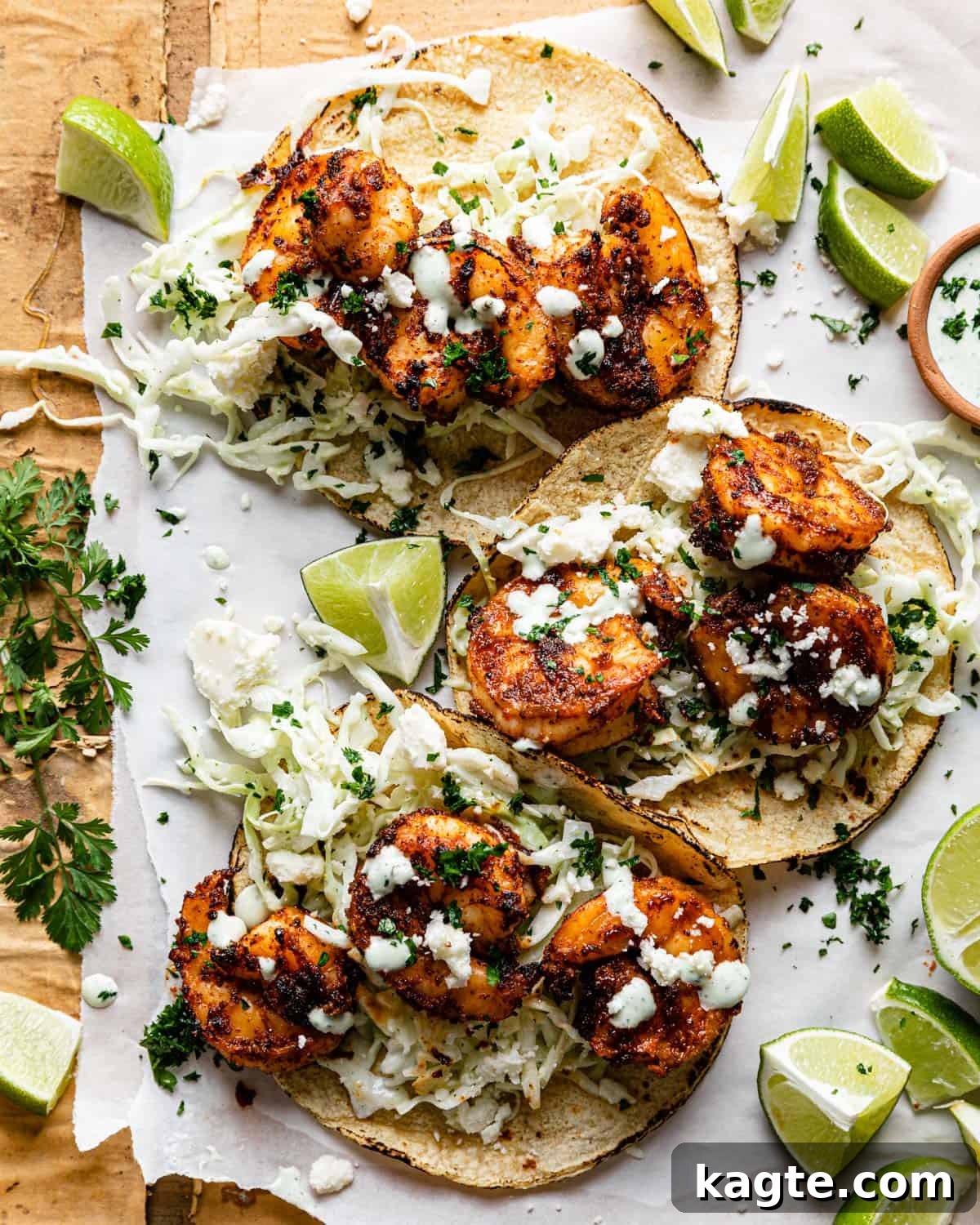 Overhead image of air fryer shrimp tacos garnished with fresh cilantro and lime wedges, showcasing their vibrant colors and appealing presentation.