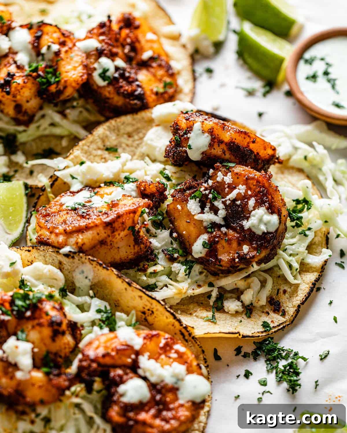 Close-up image of a perfectly assembled air fryer shrimp taco, highlighting the seasoned shrimp, creamy jalapeño lime slaw, and fresh cilantro, invitingly ready to be enjoyed.