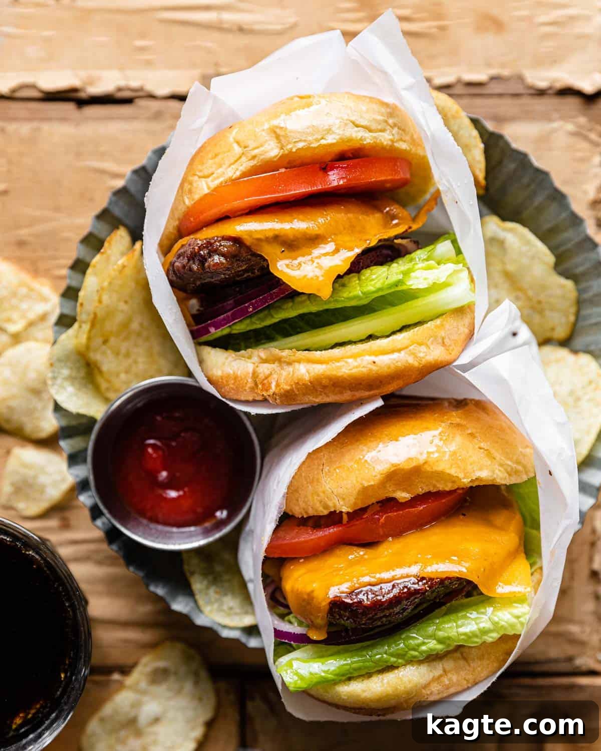From Frozen to Fabulous: Air Fryer Hamburger Patties 2 Overhead image of hamburgers with toppings wrapped in parchment paper.