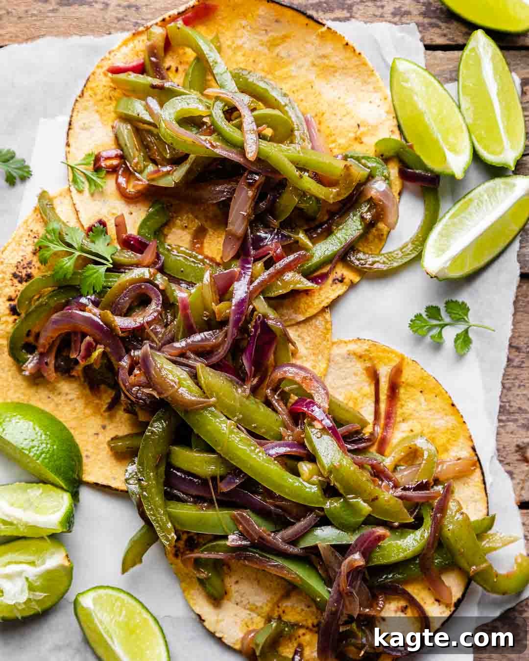 Smoky Chipotle Fajita Vegetables 2 Delicious Chipotle style fajita veggies served in warm tortillas with cilantro and lime, ready for a healthy and flavorful meal. Perfect for tacos or burrito bowls.