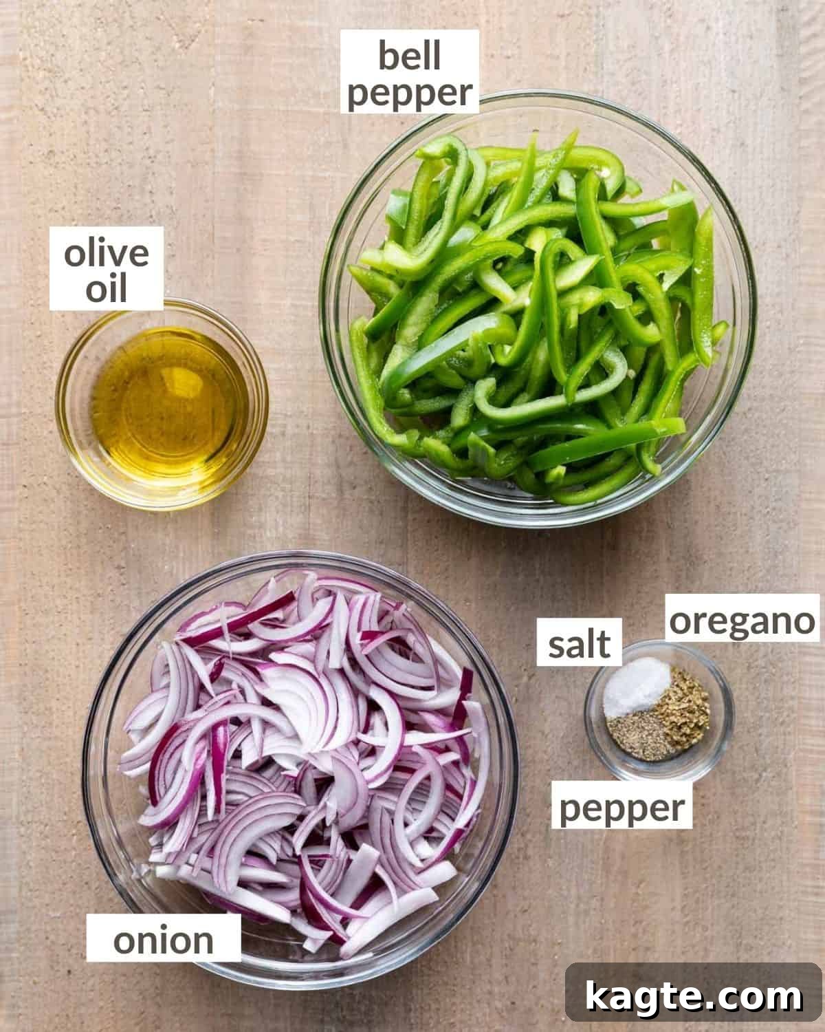 Smoky Chipotle Fajita Vegetables 3 Overhead view of fresh green bell peppers, red onions, olive oil, salt, pepper, and Mexican oregano in glass bowls, all prepared and ready for making fajita veggies.