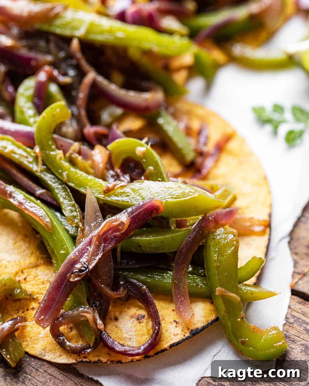 Smoky Chipotle Fajita Vegetables 6 Close-up of perfectly cooked Chipotle style fajita veggies nestled in a soft corn tortilla, garnished with fresh cilantro, inviting a delicious bite.