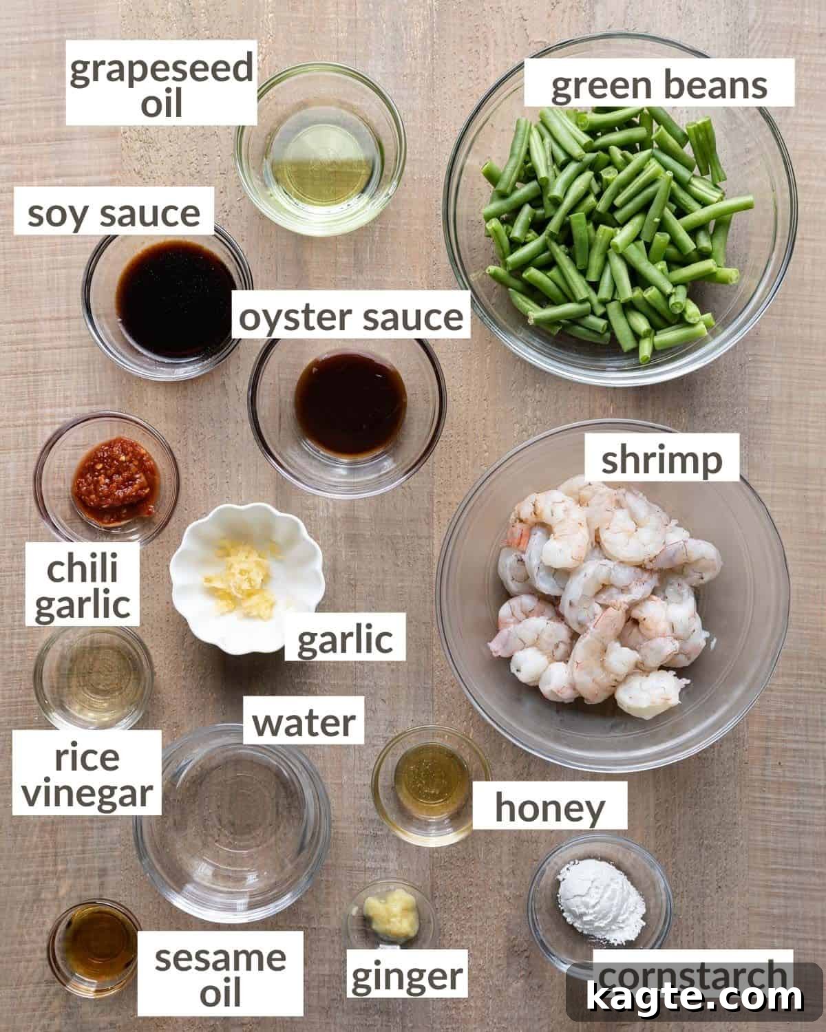 Overhead shot of all ingredients in glass bowls needed to make hunan shrimp. 