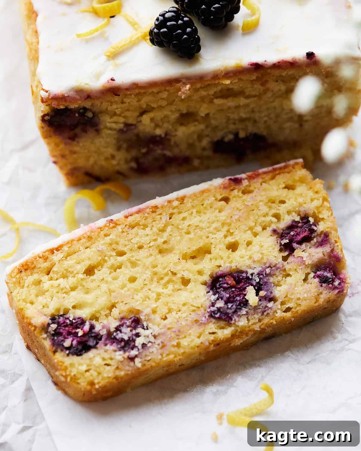 Slice on lemon blackberry bread on parchment paper.