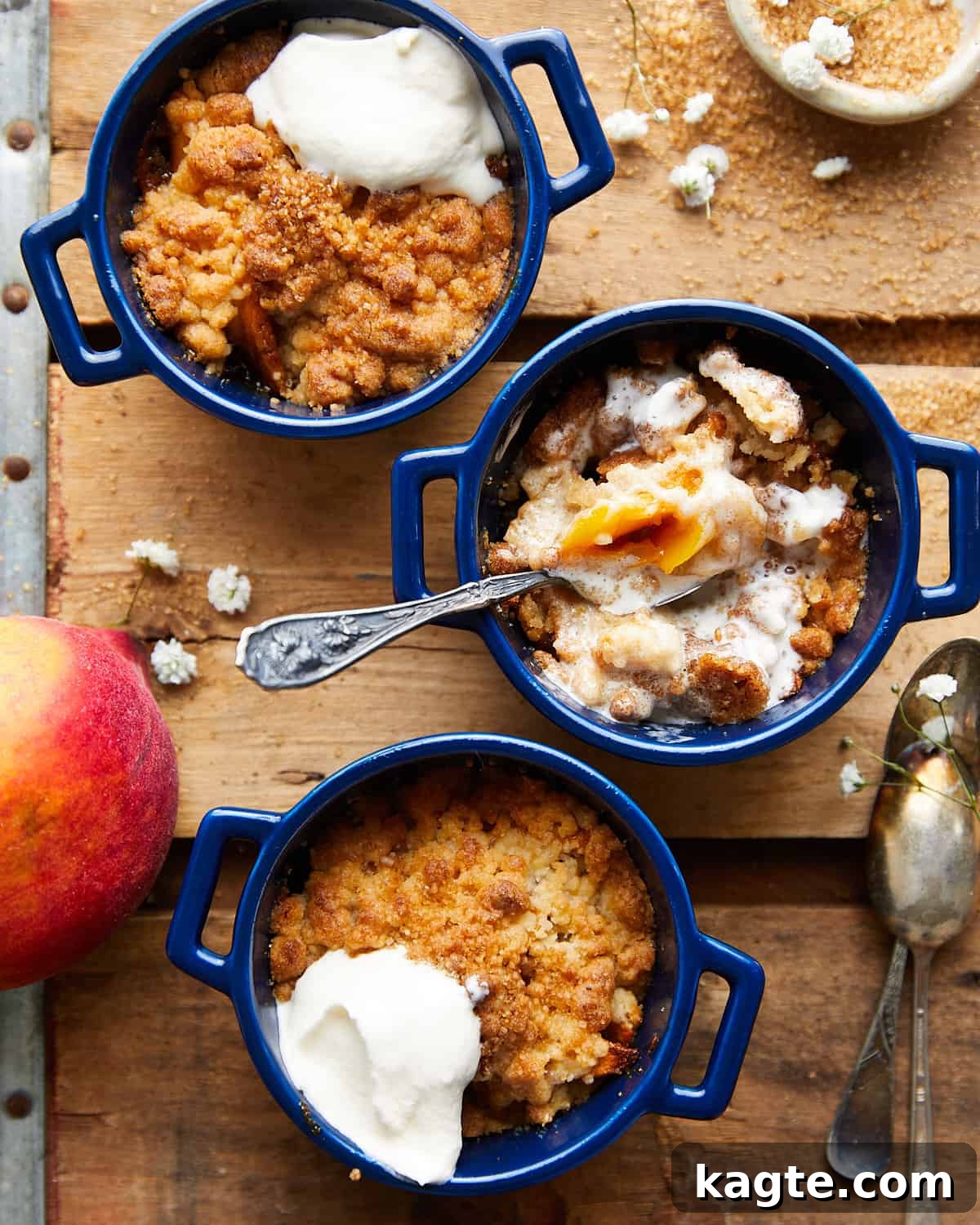 Air fryer peach cobbler with whipped cream on top, served in a charming ramekin, ready to be enjoyed.