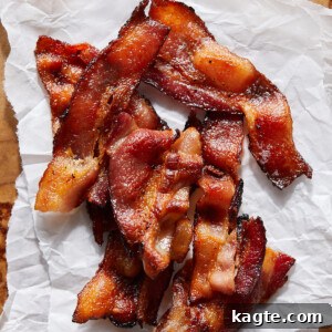 Crispy Instant Pot bacon pieces on parchment paper.