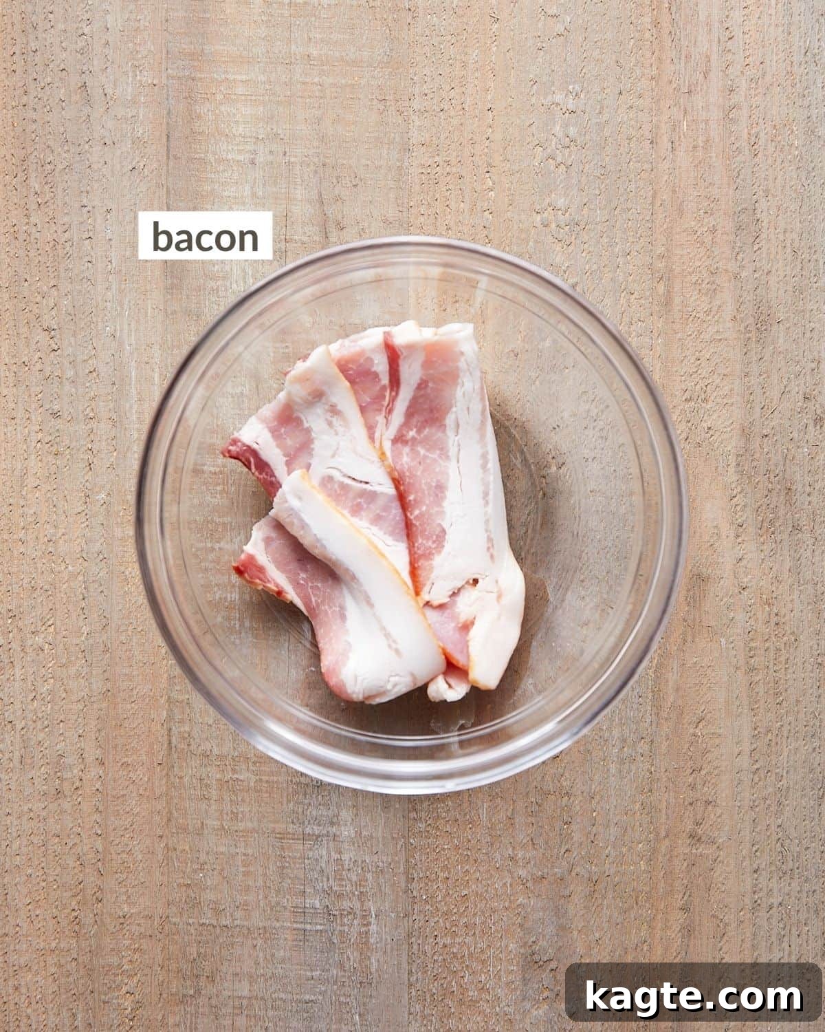Crispy Instant Pot Bacon 3 Overhead shot of raw bacon strips in a ceramic bowl, ready for cooking.