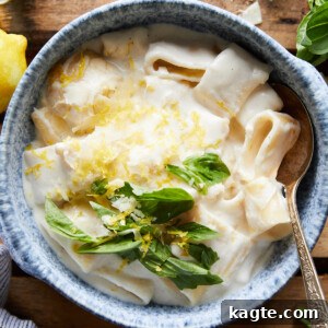 Lemon Ricotta Pasta in a bowl with lemon and basil garnish.