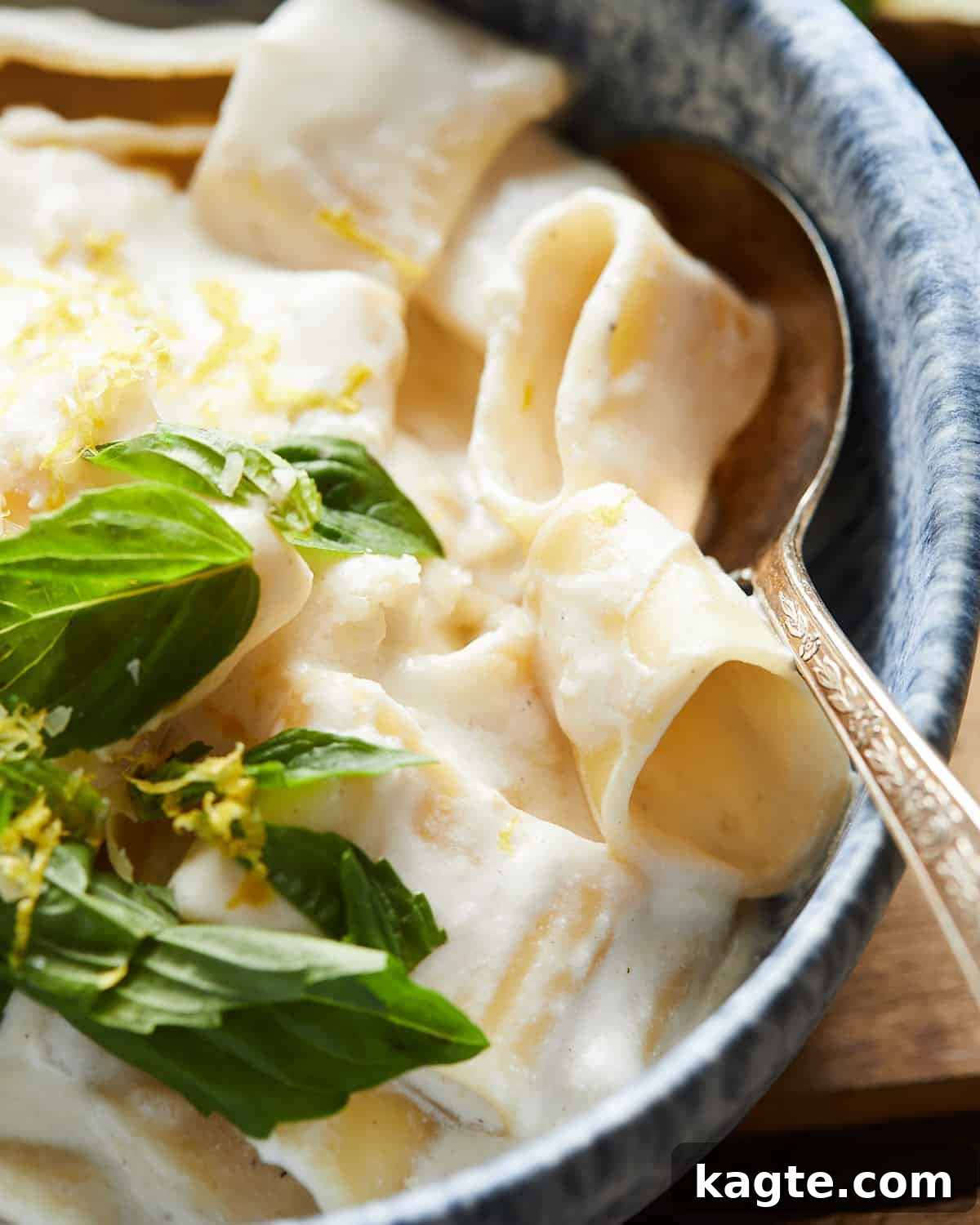 Lemon-Kissed Ricotta Pasta 7 Close up shot of lemon ricotta pasta with lemon zest, basil, and parmesan on top.