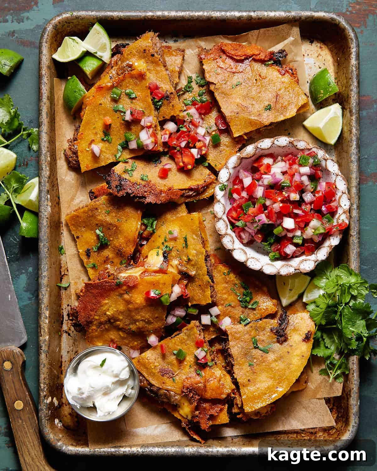 Shows finished corn tortilla quesadilla garnished with pico de gallo, cilantro, and sour crem