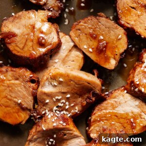 Deliciously glazed brown sugar garlic pork tenderloin on a serving plate.
