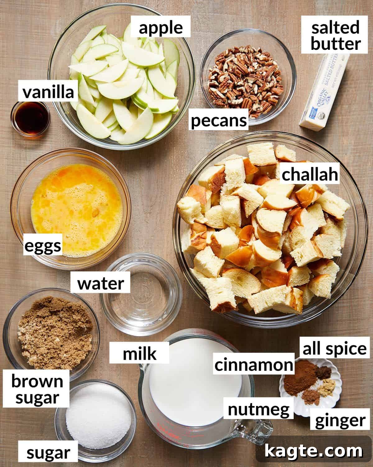 Bowls of fresh ingredients for apple cinnamon bread pudding, including sliced apples, chopped pecans, and various spices.