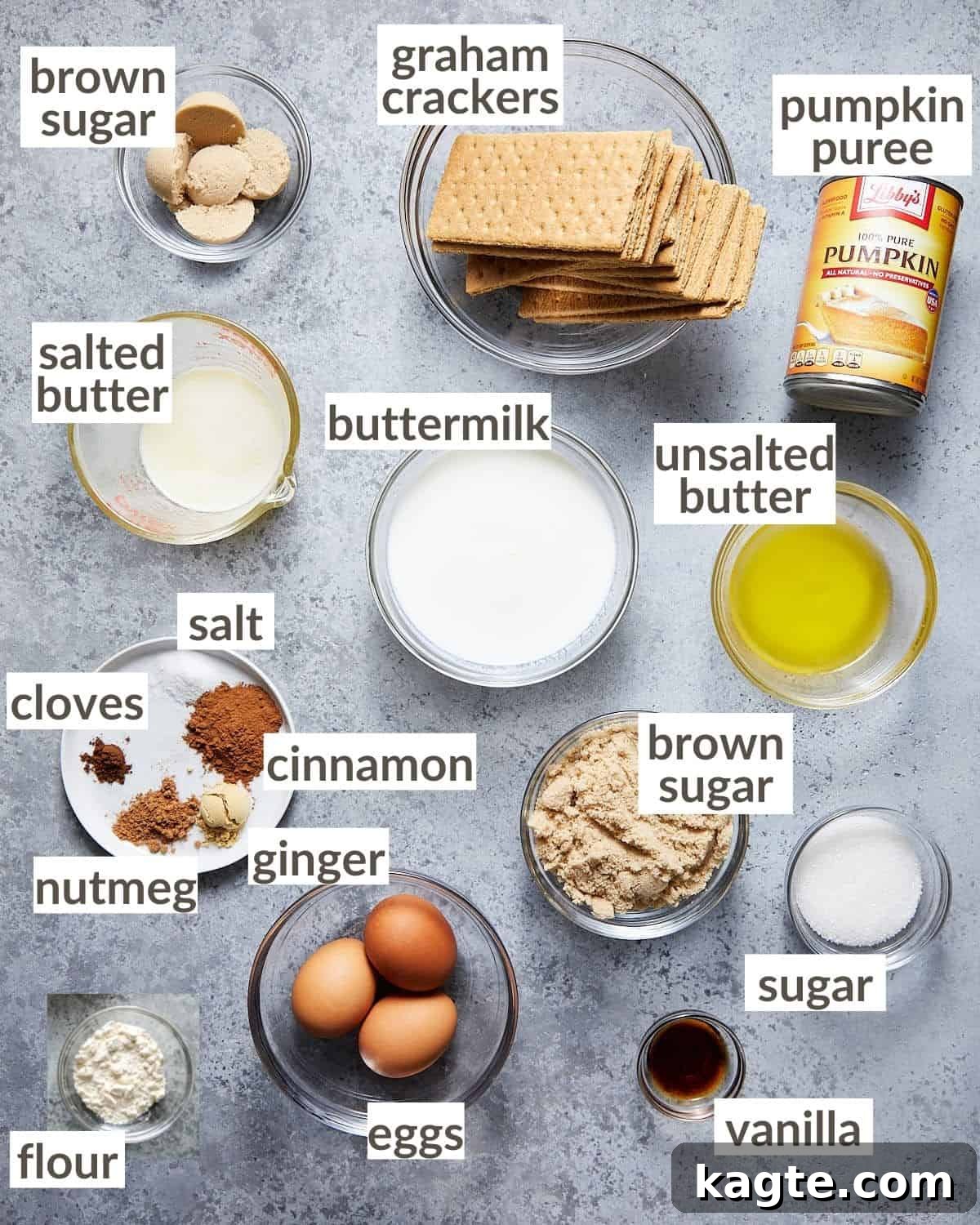 An organized display of fresh ingredients in various glass bowls, including graham cracker crumbs, melted butter, pumpkin puree, eggs, and spices, all ready for making a delicious graham cracker crust pumpkin pie.