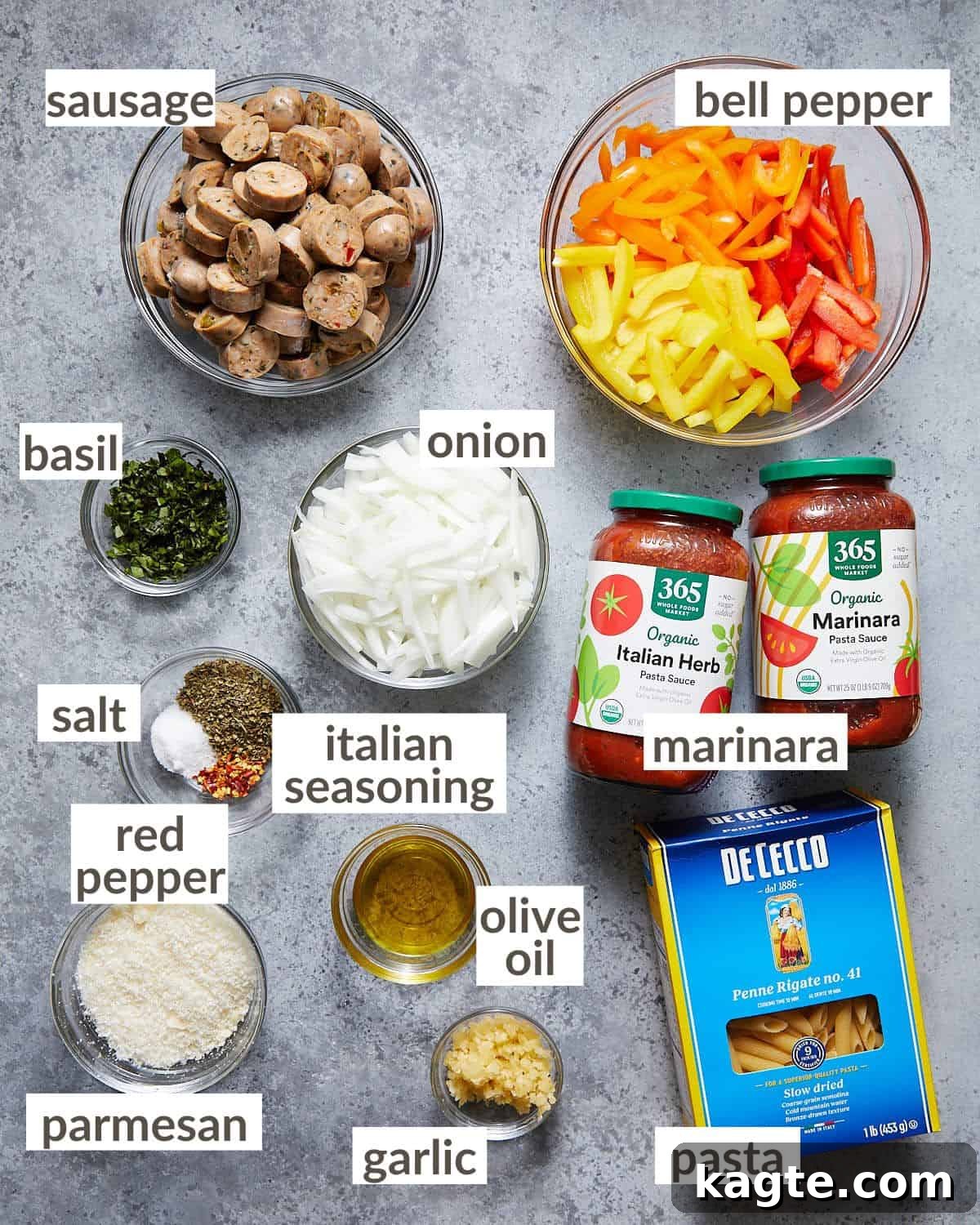 Quick Weeknight Sausage and Pepper Pasta 3 A selection of fresh ingredients including colorful bell peppers, Italian sausage, garlic, and basil, prepped in glass bowls for making sausage and peppers pasta.